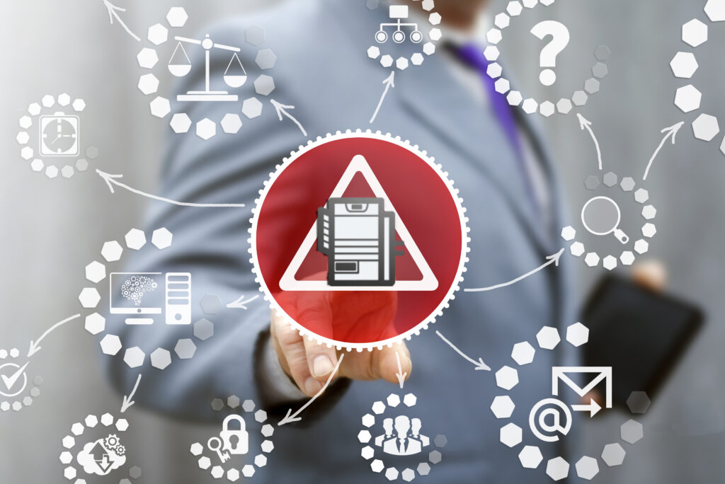 business man pointing at copier icon in warning triangle (data security)