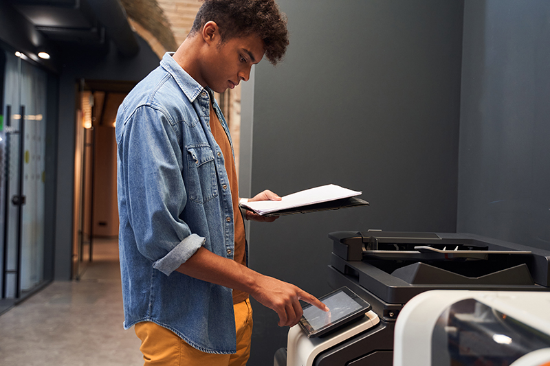 portrait,of,curly,office,confident,worker,is,printing,a,file